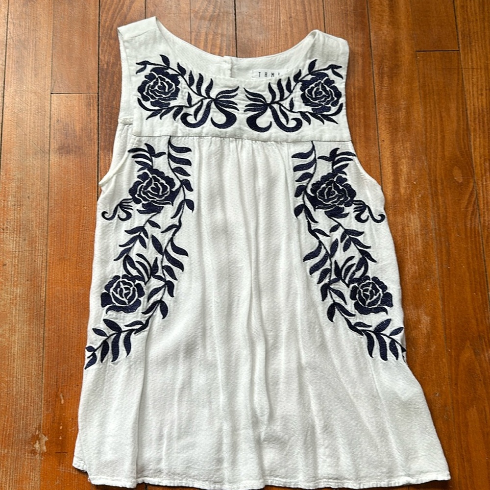 White flowy top with navy rose detail